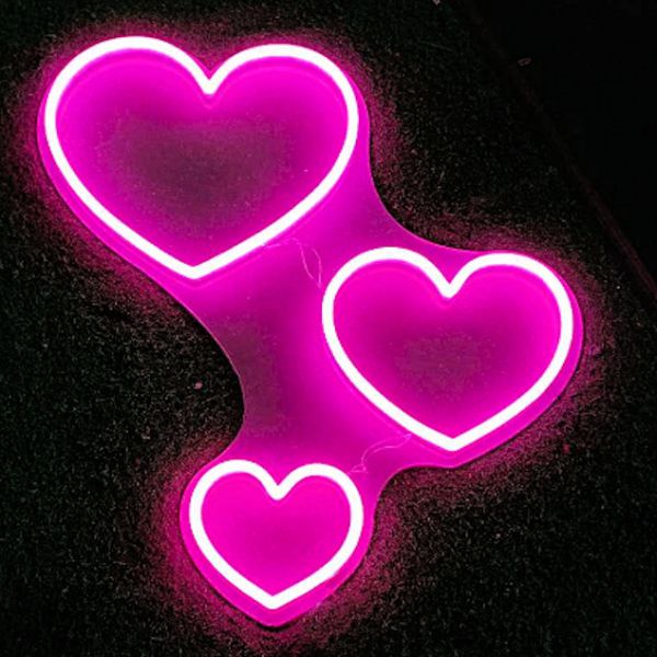 Three Hearts Light Up Wall Art shown illuminated - photo from CustomNeon.co.uk