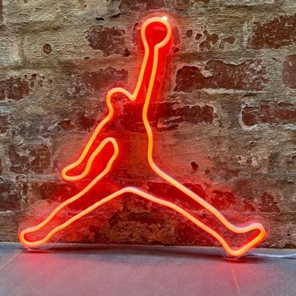 Basketball player neon art in red LED neon flex shown against a brick wall - from Custom Neon