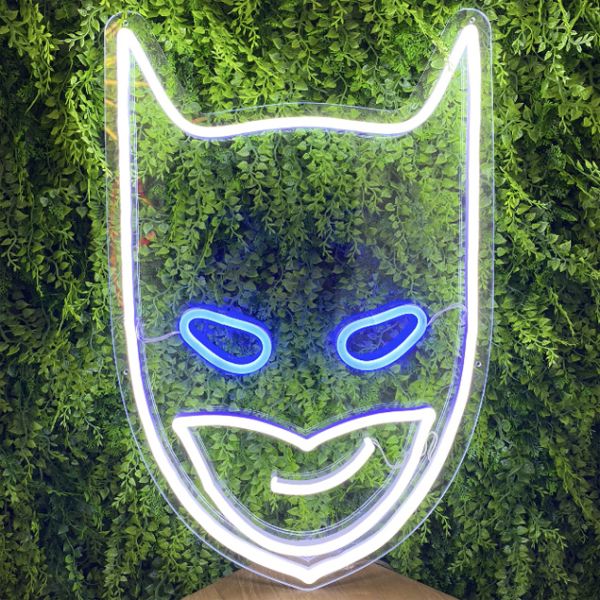 Batman neon light sign shown on green wall - photos from CustomNeon.co.uk