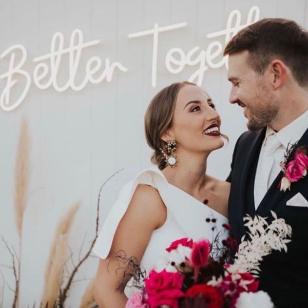 Better Together LED neon wedding sign behind the happy couple - from Custom Neon