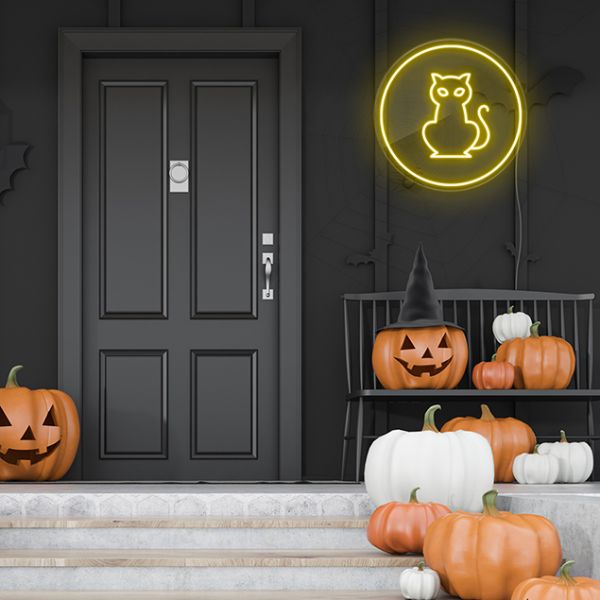 Cat Neon Light: pre-designed LED neon art from Custom Neon® shown on dark wall above jack-o-lanterns