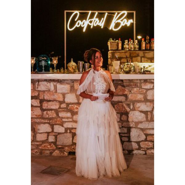 Cocktail Bar Neon Sign shown behind the bar at a wedding - photo from CustomNeon.co.uk