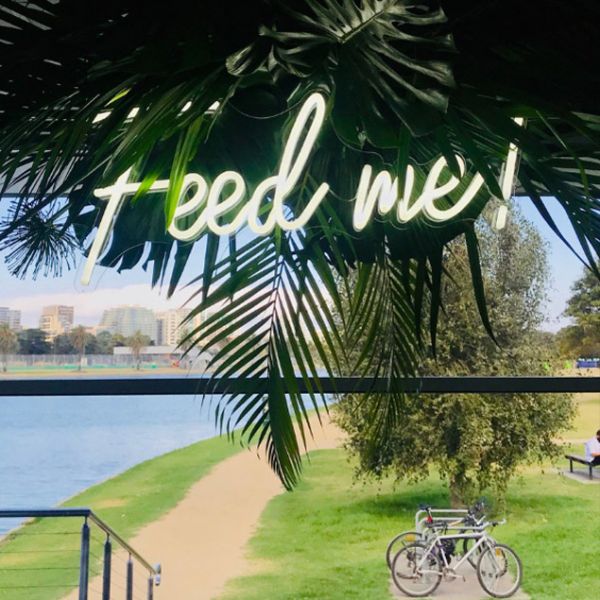 Feed Me neon sign shown in white attached to - from CustomNeon.co.uk
