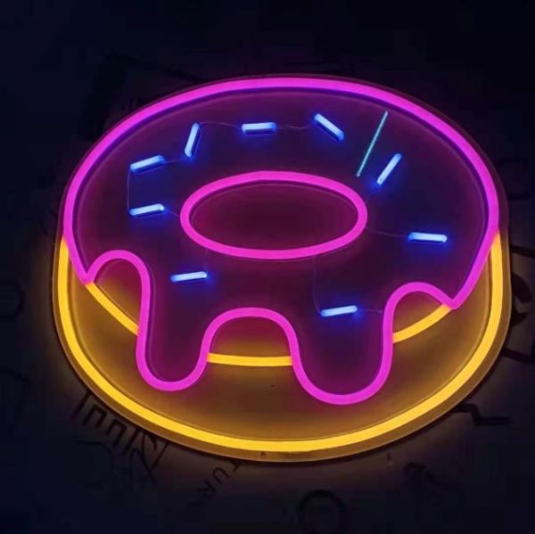 Frosted donut neon sign in pink, yellow & blue by Custom Neon®