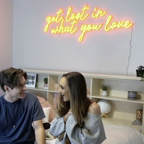 Get Lost in What You Love yellow LED neon light shown as bedroom wall art - photo CustomNeon.co.uk