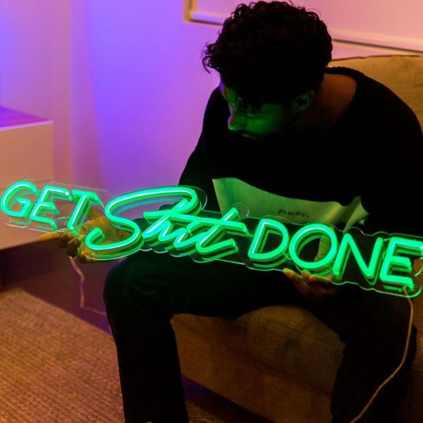 Custom Neon® green Get Shit Done wall sign shown in a bedroom setting