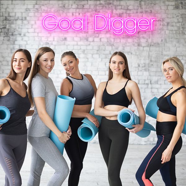 Goal Digger CUSTOM NEON® pre-designed sign shown in pink on a gym wall