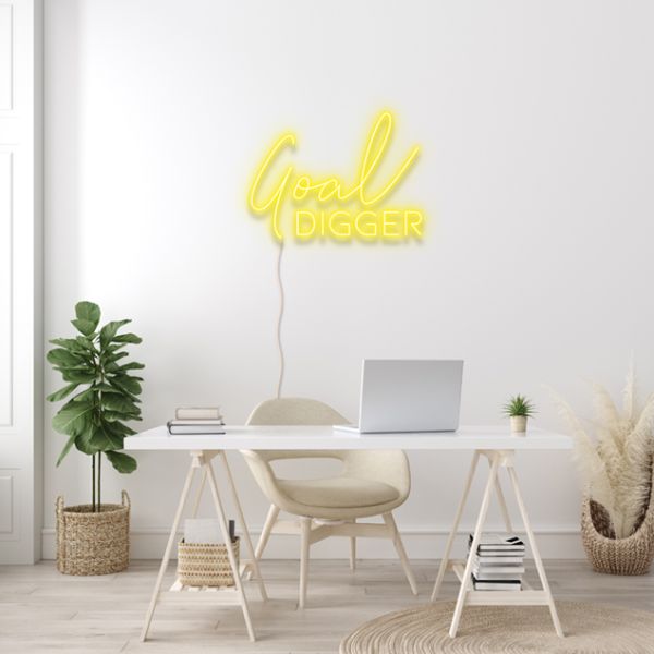 Goal Digger pre-designed CUSTOM NEON® word sign shown in yellow wall mounted above a desk