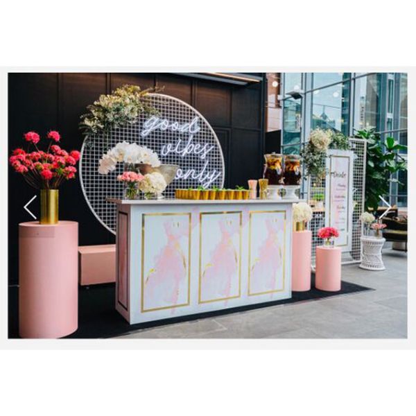 Good Vibes Only LED neon sign in 3 pieces shown behind the bar at an event - photo from CustomNeon.co.uk