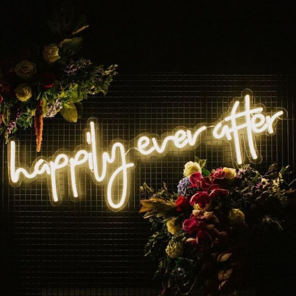 Happily Ever After LED neon sign surrounded by floral decorations - from Custom Neon