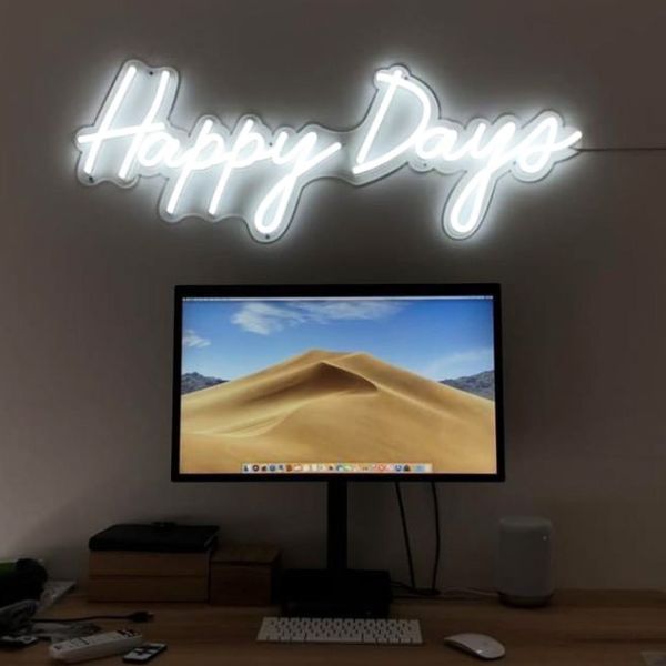 Happy Days LED neon sign shown illuminated above a monitor - photo CustomNeon.co.uk