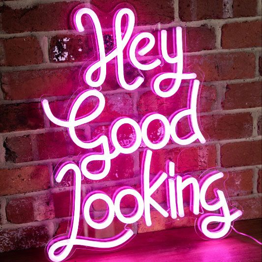 * Hey Good Looking * neon word sign shown on exposed brick wall  - photo from CustomNeon.co.uk
