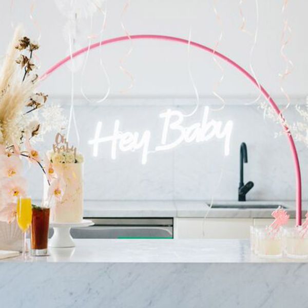 Hey Baby Light Up Sign shown with Baby Shower decorations - photo from CustomNeon.co.uk