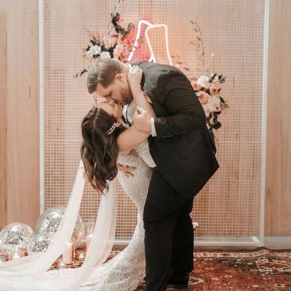 Holding hands in pink and red LED neon flex made by @customneon, styled for a wedding @thewarehousegeelong @theposieplace