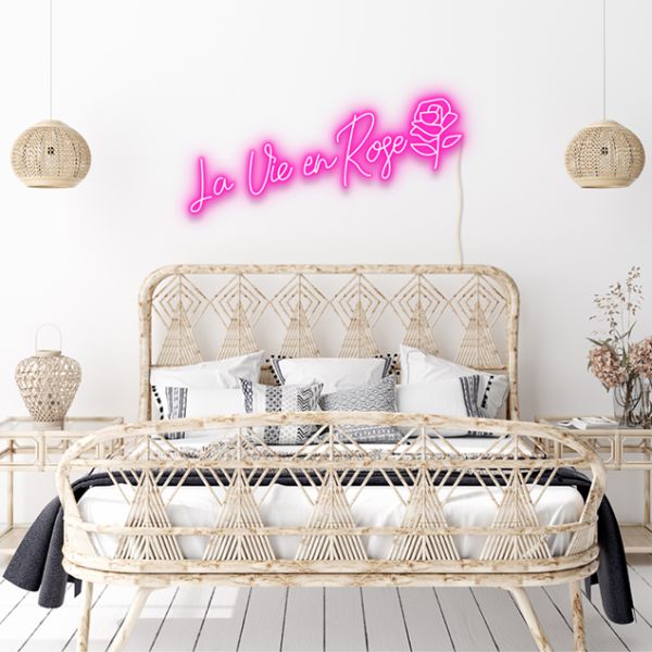 La Vie En Rose pink neon flex wall above a bed - from Custom Neon