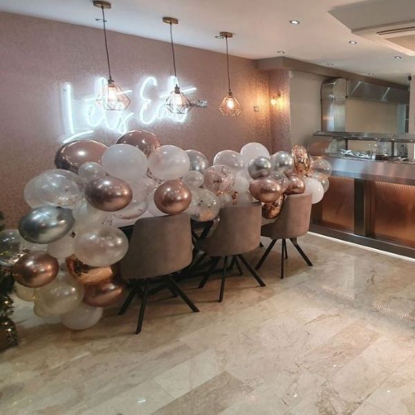 Let's Eat Neon Look Sign shown in a restaurant - photo from CustomNeon.co.uk