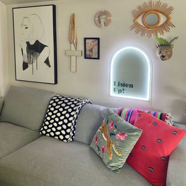 Listen Up! white & green neon art shown turned on & wall mounted above a sofa @customneon Signs of Change charity range