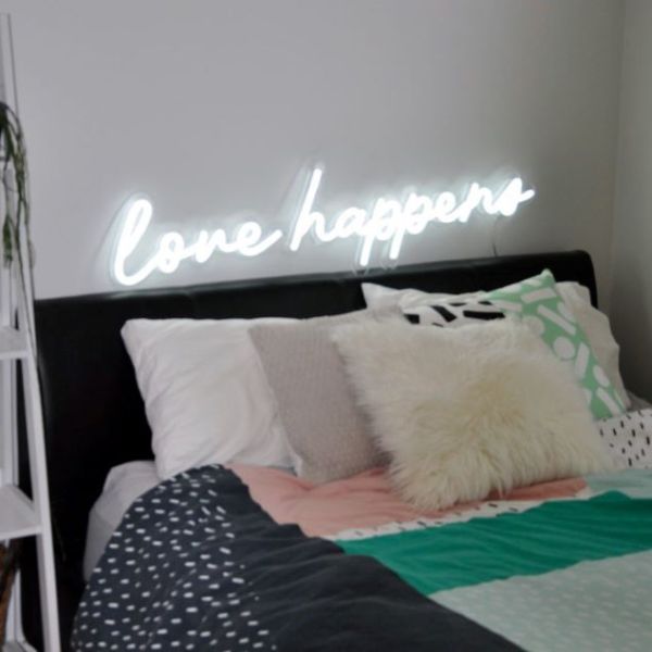 Love Happens faux neon sign above bed as bedroom decor - from Custom Neon®