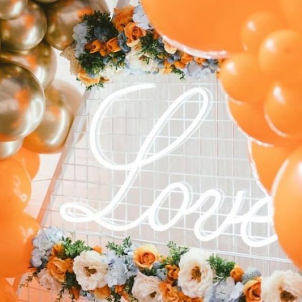 Romantic Love Sign in LED Neon Flex shown in white surrounded by wedding decorations - from Custom Neon™
