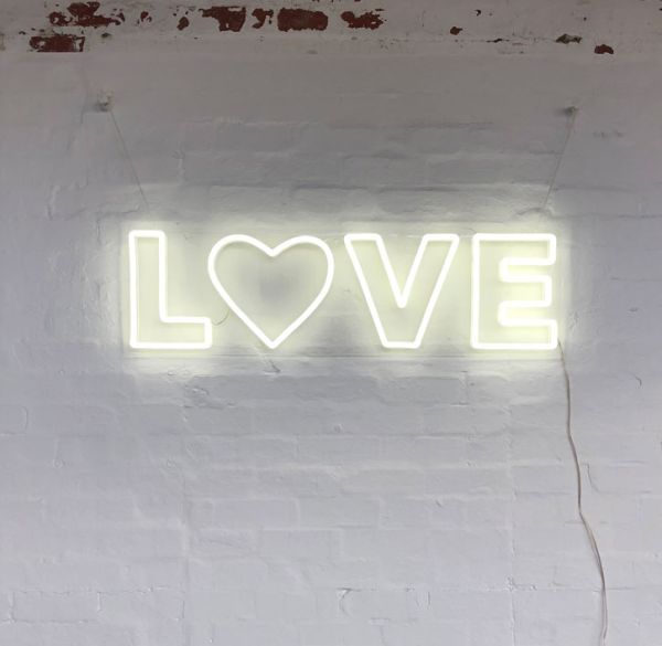 Love LED Neon Letter Light mounted on brick wall
 - photo from CustomNeon.co.uk