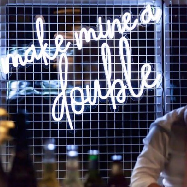 Make Mine a Double trendy LED neon bar sign behind the open bar at an event  - photo from CustomNeon.com