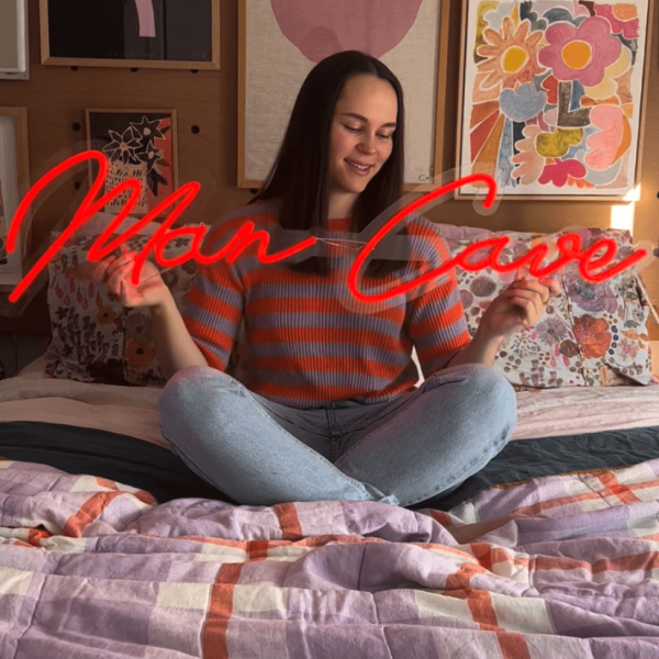 Red Custom Neon® Man Cave sign shown in a bedroom