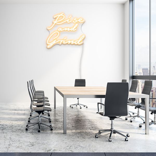 Rise and Grind off white CUSTOM NEON® sign shown on office boardroom wall