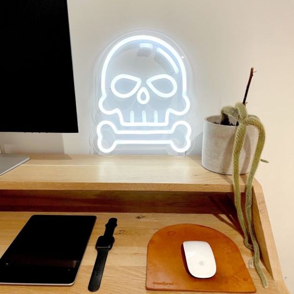 Skull & Bone white Custom Neon® art on a desk