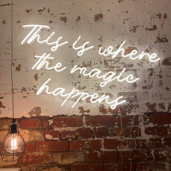 This is Where the Magic Happens white neon flex sign on distressed brick wall - from Custom Neon