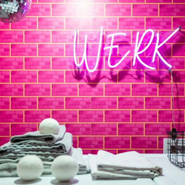 WERK pink light sign by CUSTOM NEON® shown on pink tiled laundry room wall @brownstoneboys