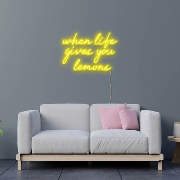 When Life Gives You Lemons yellow neon flex sign wall mounted above a sofa - design by Custom Neon

