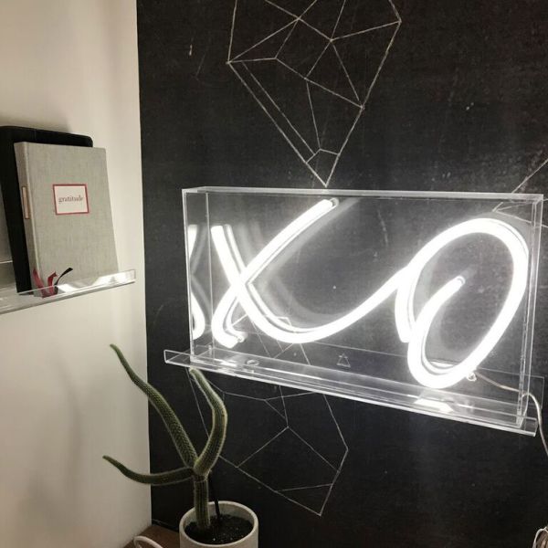XO neon sign in acrylic box shown on a thin acrylic shelf as wall art - from CustomNeon.co.uk