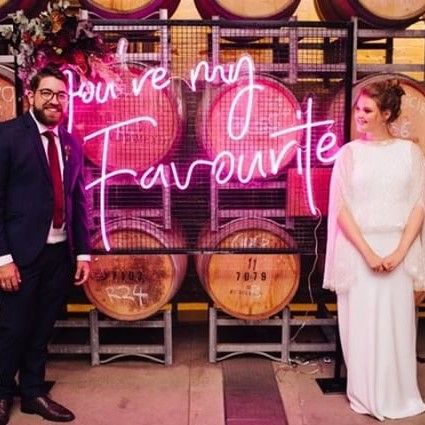 You're My Favourite pink light sign in front of wine barrels at a wedding - from Custom Neon