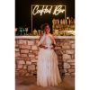 Cocktail Bar Neon Sign shown behind the bar at a wedding - photo from CustomNeon.co.uk