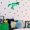 Personalised name sign in LED neon with dinosaur background shown in child's room - from CustomNeon.co.uk