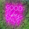 Good Vibes Only Trendy LED Neon Light in Two Fonts shown in pink on green wall from Custom Neon