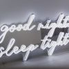 Good Night Sleep Tight white LED on silver mirrored backing shown in slightly dim light - CUSTOM NEON® 