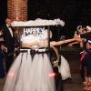 Happily Ever After portable neon sign with battery pack, shown attached to the bridal buggy - photo from CustomNeon.co.uk