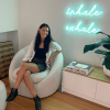 Inhale Exhale Custom Neon® wall sign shown illuminated on a white wall
