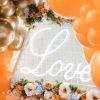 Romantic Love Sign in LED Neon Flex shown in white surrounded by wedding decorations - from Custom Neon™