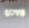 Love LED Neon Letter Light mounted on brick wall
 - photo from CustomNeon.co.uk