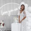 Love You XO LED neon light shown on a mesh screen with balloons, wedding cakes and the beautiful bride - photo CustomNeon.co.uk @customneon