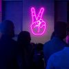 Neon Peace Sign aesthetic neon light shown wall mounted in a bar - from Custom Neon®