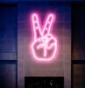 LED Neon Peace Sign Wall Art shown mounted above a fireplace - photo from @CustomNeon