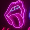 Custom Neon® pink tongue shown illuminated against a dark background in dim light