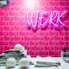 WERK pink light sign by CUSTOM NEON® shown on pink tiled laundry room wall @brownstoneboys