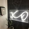 XO neon sign in acrylic box shown on a thin acrylic shelf as wall art - from CustomNeon.co.uk