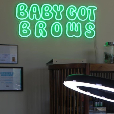 Green Custom Neon® brow bar sign in a cartoon style double-lined font script font