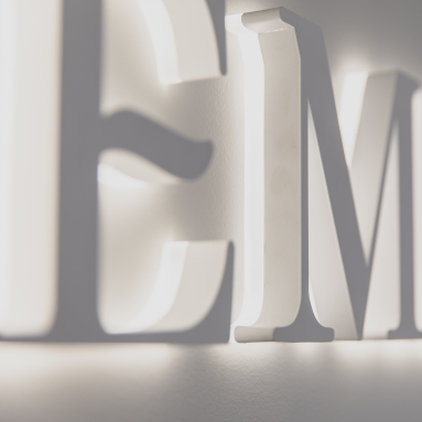 Custom Neon® backlit channel letters on a white wall