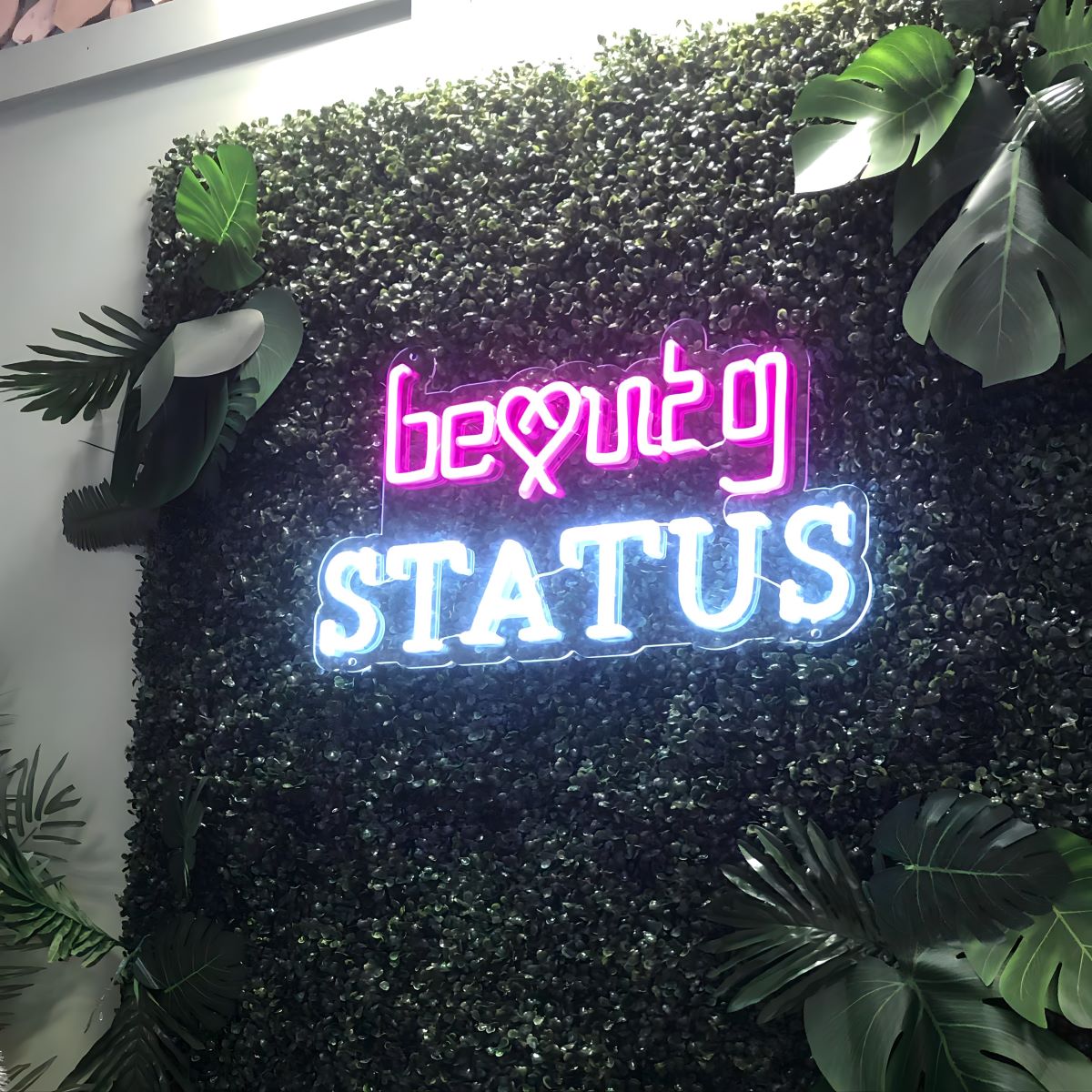 Custom Neon® beauty salon sign on greenwall @beautystatus.uk